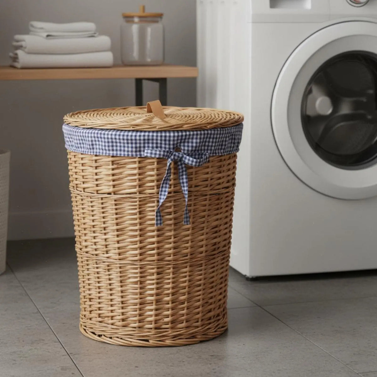 Lidded wicker laundry basket with blue check liner beside a washing machine