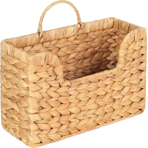 Woven plant fibre wall basket on a plain white background
